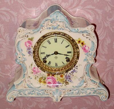 C.1905, Ansonia Clock Co., La Lorne, Royal Bonn china clock in cream color with sky blue accents and pink-yellow floral decorations. — Antique Clocks Price Guide