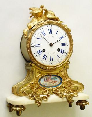 C.1860, French, Hatton a'Paris, Ormolu  and marble mantel, surmounted by two finely chased doves, and below the dial a porcelain china plaque with a hand painted cherub floating in the clouds. — Antique Clocks Price Guide
