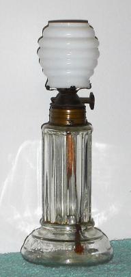 C.1890, American, Novelty oil lamp that displays the time as the oil is used up. — Antique Clocks Price Guide