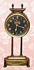 C.1900, English, Gravity Clock, round brass canister contains movement, driven by its own weight when lifted on two columns with side teeth. 