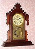 C.1890, Ansonia,"ATLAS", Walnut cased gingerbread clock, 8-day time and gong strike. 