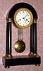 C.1800, French, Empire Pinwheel regulator, with grid pendulum, black marble portico style case with 4 columns w/ top and bottom ormolu capitals, and with vernier beat set. 