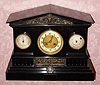 C.1900, Japy Freres, 8-day time/strike, black marble and bronze mantel clock with circular thermometer and barometer. 