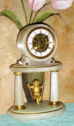 C.1890, French, Swinging Doll Timepiece, with skeletonized front plate showing the wheels of the movement. — Antique Clocks Price Guide