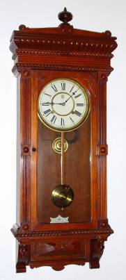 C.1893, Waterbury Clock Co., "Leeds", 8-day time and gong strike wall clock, in walnut. — Antique Clocks Price Guide