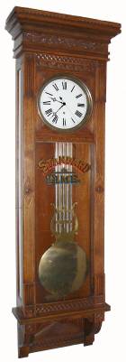 C.1885, Waterbury Clock Co., "Regulator No. 7", oak cased pinwheel jeweler's regulator, center sweep seconds, porcelain dial, lyre pend, and with original glass reading "Standard Time". — Antique Clocks Price Guide