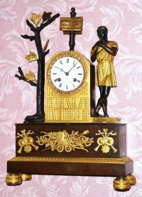 C.1850, French, A. Duminil, Paris,  8-day time and bell strike silk thread suspension figural mantel clock in the form of a Roman figure in a tunic standing and playing a flute. Retailed by Henard, Paris. — Antique Clocks Price Guide