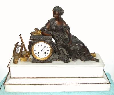 C.1880, French, Bronze and White Marble figural clock of MUSIC, with her harp and trumpet at her right. — Antique Clocks Price Guide