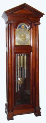 C.1905, English, J. J. Elliott, 121 Rosebery, London, 9-Tube, Quarter Chime, Rolling Moon, Hall clock, 2-tune, Westminster or Whittington, in a mahogany case with full round columns and an architectural top. — Antique Clocks Price Guide