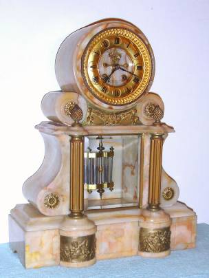 C.1880, French, for J. E. Caldwell and Co, Philada, tan onyx mantel clock with open escapement on the onyx dial center, and with 2 vial compensating pendulum. — Antique Clocks Price Guide