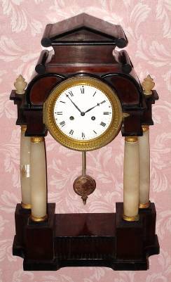 C.1830, Austrian, Walnut veneer over pine, 1-day time and strike mantel clock in classic portico style with alabaster columns. — Antique Clocks Price Guide