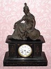 C.1900, French, Japy Freres, 8-day time and strike black marble with an added figure mantel clock. 