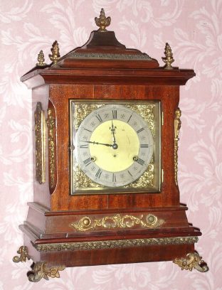 C.1895, New Haven Chime No. 3, Westminster tune, mahogany case with cast trim. This is a nice clean example with all of its applied decorations intact and a clean dial. An auxiliary movement below the striking movement, chimes the quarter hour on four gongs, followed then by strike on larger gong. Three is a patent "echo chamber" in the base of the clock. It has a clean label that was misapplied at the factory as it mis-states this to be the "Abbey" model. This model is pictured on p.96 of Ly's New Haven Clock Book with a 1997 value of $625. — Antique Clocks Price Guide