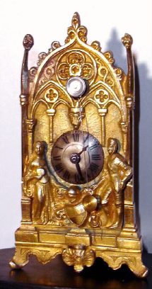 C.1800, Austrian, Zappler with front hung "cows tail" pendulum, the dial affixed to a gilt facade, flanked by two figures, and a shield below, and with a later glass dome. — Antique Clocks Price Guide