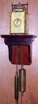 C.1870, Japanese Lantern clock, time, strike and alarm, weight driven, balance regulated, and with calendar apertures below 5 and 7, and with a gilt brass case, fretted to both sides and the rear, plus later wall bracket. — Antique Clocks Price Guide