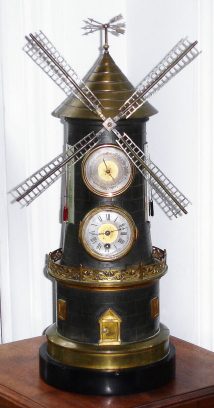 C.1880, French, Guilmet, Paris, "WINDMILL", clock from the Industrial series, a timepiece movement in the tower, and the mill blades turned via a cord travelling up the tower from a separate movement in the base, and wound by opening the "door of the mill", and with an Aneroid barometer above the clock. — Antique Clocks Price Guide