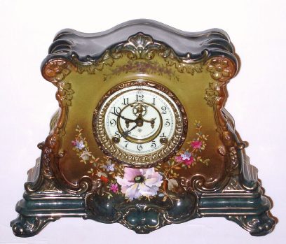 C.1910, Ansonia Royal Bonn, LA DROME,  porcelain china clock in dark New Art colors, very dark green top and bottom with lighter shaded front and dark pink accents, the porcelain dial with open escapement. — Antique Clocks Price Guide