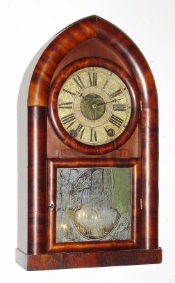 C.1841, Rare Brewster and Ingrahams, Detached Fusee Beehive, 8-day time and repeating rack strike [Kirk's patent] in a mahogany veneered case and with old Fenn tablet, and wooden dial. Note this clock was made at a time when Joseph S. Ives (Nephew of THE Joseph Ives) was working with Brewster and he secured a patent for the use of brass as a spring in clocks. We sold the sister to this clock, lot 385 in May of 2004, that had a full Joseph S. Ives label. That clock [385] crossed the block at $6100. — Antique Clocks Price Guide