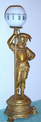 C.1890 French figural "night" clock. Statue of Indian holding a post with a glass globe, pointer and 8-day time-only movement, cylinder platform. — Antique Clocks Price Guide