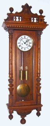 C.1885, German, Gustav Becker, 2-Wt, Vienna Regulator, in a walnut case with vines carved into the columns, and with original top, mov't with 2 hammers and striking bim-bam [not quarters]. — Antique Clocks Price Guide