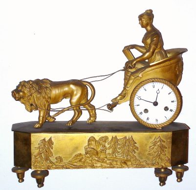 C.1830, French Ormolu figural clock, small. 8-day time and strike silk-suspension movement, a lion pulling a chariot with female driver. — Antique Clocks Price Guide