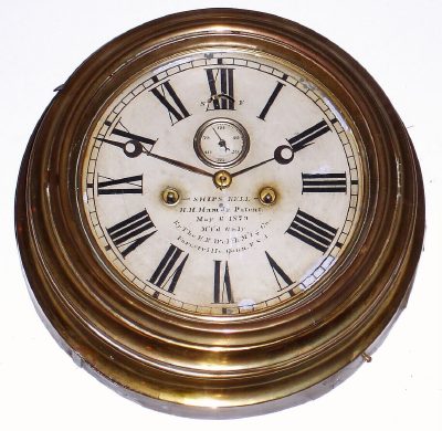 C.1880, E. N. Welch, Ship's Bell wall clock in a spun brass case w/ painted 7" dial. Signed on dial "H. H. Ham, Jr, Patent, May 6, 1879, Mf'd Only by the E. N. Welch M'fg Co., Forestville, Conn, U.S.A.". — Antique Clocks Price Guide