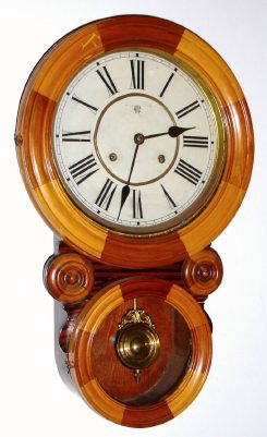 C.1891 Waterbury Clock Co., Waterbury, CT:  Bahia Mosaic model in contrasting maple and walnut woods with 8-day time and strike movement. — Antique Clocks Price Guide