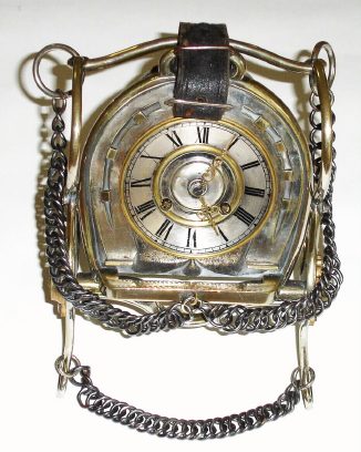 C.1890, French, Silvered brass, HORSE THEMES, mantel clock, the clock set into the center of a horse shoe, the whole supported by two different bits, chain and leather strapping. — Antique Clocks Price Guide