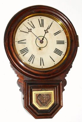 C.1900, E. Ingraham, Bristol, Conn, DEW DROP, 8-day timepiece, in a grained poplar case and with partial label on the rear. — Antique Clocks Price Guide