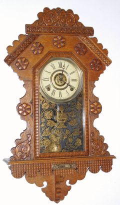 C.1896, E. Ingraham and Co., HANGING GINGERBREAD, from the Chicago line, pressed oak, 8-day time strike and alarm. — Antique Clocks Price Guide