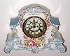 C.1904, Ansonia Clock Co., Royal Bonn LA NORD, porcelain china clock in tu-tone sky blue and white with magenta colored rose bottom center, plus gold highlights, the porcelain dial with open escapement. 