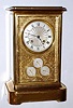 C.1880, French, Bourdin, Paris, Calendar clock, with day date and month showing on three separate dials below the main time dial, all 4 set into an engraved and gilded mask with fine detail. Silvered time dial engine turned at the center. Finely made movement signed Bourdin a` Paris on the rear plate, and with a 2-vial compensating pendulum. 