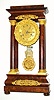 C.1850, French, Empire Style 4-Column portico clock, in crotch mahogany with fire gilt accents, the movement with no marks and with venier beat adjustment. 