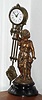 C.1890, French, Small Swinger, or mystery swinging timepiece, foot long clock arm suspended on a child in a dress. Dial of clock = 2", rear wind. 