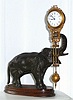 C.1910, German, Junghans, ELEPHANT,  patinated spelter mysterious swinging timepiece, 8-day, on a shaped wooden base with molded edge.