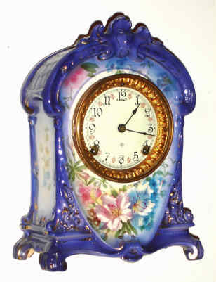 C.1904, Ansonia Clock Co., Royal Bonn La Cruz, porcelain china clock in a royal purple color, with floral accents. — Antique Clocks Price Guide