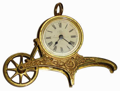 C.1885, Ansonia Clock Co., Wheelbarrow novelty timepiece, a rear-wind "Bee" movement in a cast brass holder simulating a wheel barrow, with turning front wheel, design patent Apr 23,1878. — Antique Clocks Price Guide