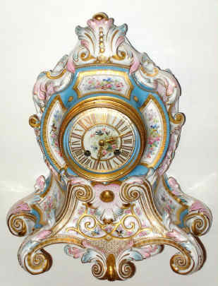 C.1890, French, Etienne Maxant, Paris, Porcelain China Clock in the style of Louis XV, white with hand painted floral decorations, pink and blue accents and gold highlights, also with decorated dial and gilt hands, retailed by Bailey Banks and Biddle, and with matched serial number pendulum. — Antique Clocks Price Guide