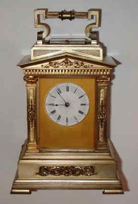 C.1890, French, Brass Cased Carriage clock, in a large architectural case w/ pediment top, with tu-tone gilding, each corner with square columns and Corinthian capitals on each, dentil molding all 'round the top and cast floral decorations below the roof line, and on all 4 sides of the base; time, strike and repeat, 8-day with original platform. — Antique Clocks Price Guide