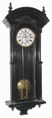 C.1875, German, 2-Wt, Vienna Regulator, in an ebonized case, the unusual movement with exposed escapement on the dial, and with dead beat, dial signed, Wm Bremer, Jr., Hamburg. — Antique Clocks Price Guide