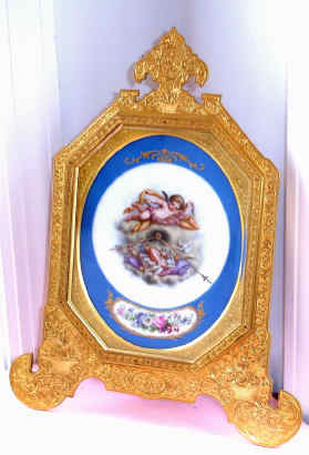 C.1900, English, attributed to Thomas Cole, engraved and gilt strut clock, with a hand painted dial scene of a cherub in the clouds, overlooking a music book and tambourine and 2 doves. — Antique Clocks Price Guide