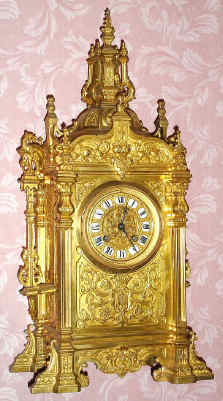 C.1890, French, Large Gilt Brass Architectural clock, the substantial case with buttresses and fancy finials, now with another movement from the same period, with fancy cast dial and individual cartouche numerals. — Antique Clocks Price Guide