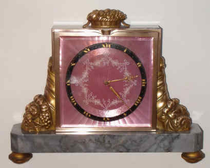 C.1920, Swiss, Gubelin, Lucerne, Ormolu and Marble time and strike desk clock, jeweled lever escapement, rear wind, striking on internal coiled wire gong. The dial with pale pink guilloche enamel. — Antique Clocks Price Guide