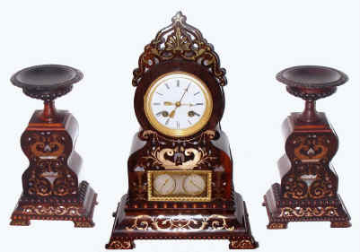C.1830, French, Rosewood, 3-pc mantel set with inlays of brass and ivory, the well made movement with silk thread suspension, and actuating the calendar below by a vertical rod; with thumb screws to adjust the calendar at the end of short months, and two matching side pieces. — Antique Clocks Price Guide