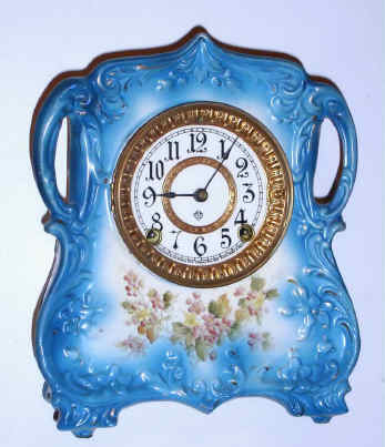 C.1910, Ansonia TRINKET, Porcelain china clock, 8-day time and strike with paper dial,, in deep sky blue. — Antique Clocks Price Guide