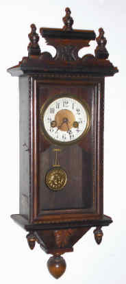 C.1920, German, Small 30 Hour wall clock, pine case with walnut finish and embossed trim. — Antique Clocks Price Guide