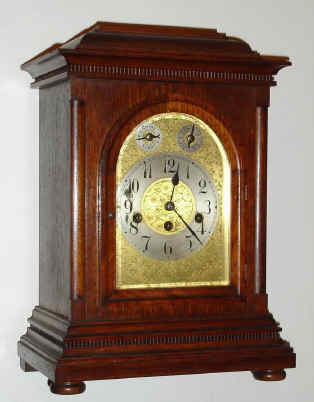 C.1910, German, Junghans, WESTMINSTER CHIME mantel clock, oak, with embossed brass dial with regulation in the arch for F/S and Chime-Silent. — Antique Clocks Price Guide