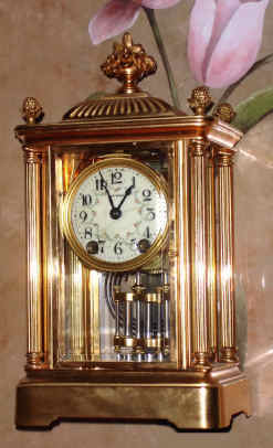 C.1907, Seth Thomas Clock Co., EMPIRE No. 44, 4-Glass or crystal regulator, in a fancy column case, gold plated and with floral finials and top urn. — Antique Clocks Price Guide