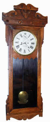 C.1905, American Wringer Co., (by New Haven Clock Co.), 30-day spring wall regulator. This is the timepiece version of the double dial calendar model in this auction (lot 238). — Antique Clocks Price Guide