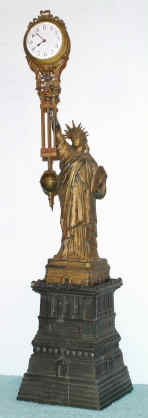 C.1905, German Swinger, Junghans, now on a spelter statue of LIBERTY, sold originally as a 1920S souvenir, and converted to a swinging arm. — Antique Clocks Price Guide